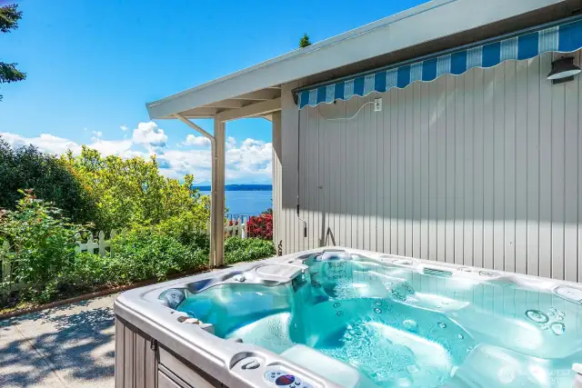 Th hot tub is located off the primary suite and front entrance.