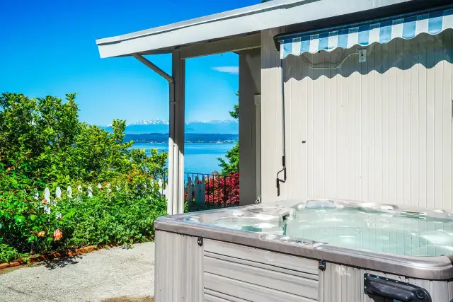The hot tub is located off the primary suite and front entrance.