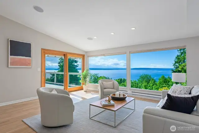 The living room has vaulted ceilings, refinished hardwood floors, access to the spacious deck and endless views.