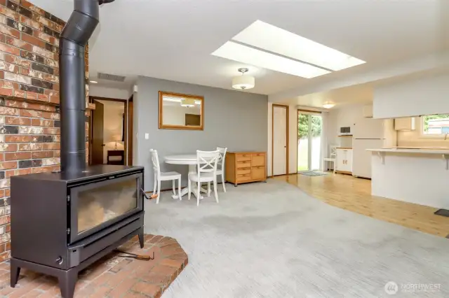 Close-up of wood stove and looking towards kitchen.