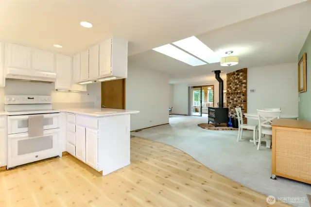 Kitchen has freshly painted cabinets, recessed lighting and a double oven.