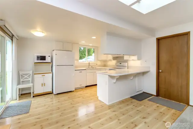 Full shot of the bright, practical and uncluttered kitchen.