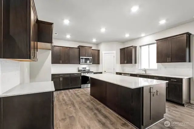 Quartz counters with undermount sink. Photos are for representational purposes only. Some colors and finishes may differ.