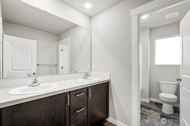Nice to have a door on the water closet in the guest bath. Photos are for representational purposes only. Some colors and finishes may differ.