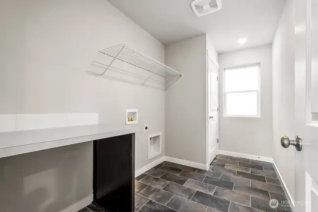 Utility room will have built in cabinets and folding table. Photos are for representational purposes only. Some colors and finishes may differ.