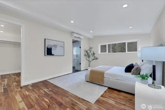 Relax and unwind in the spacious primary bedroom with serene views and natural light.