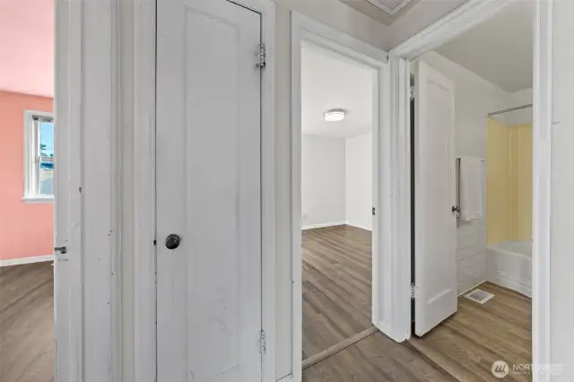 A central hallway connects the living spaces to the additional bedrooms, along with a conveniently located full bath, offering a comfortable flow throughout the home.