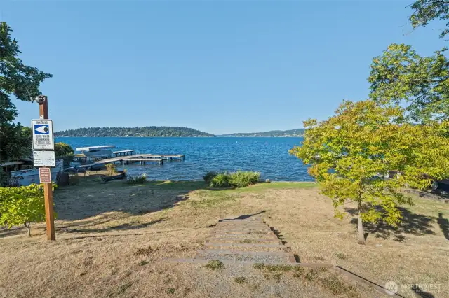 Steps leading down to the shared beach, offering easy access to the lake and sweeping water views.