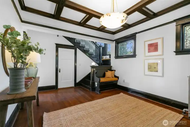 Original craftsmanship shines in the built-in bench, detailed millwork and spacious coat closet