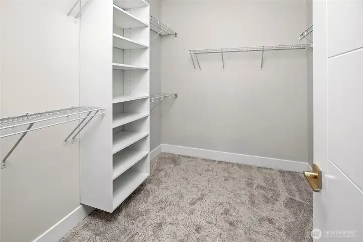 built-in shelving in primary walk-in closet