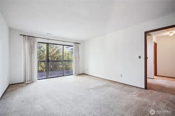 Primary bedroom w/ access to expansive deck.
