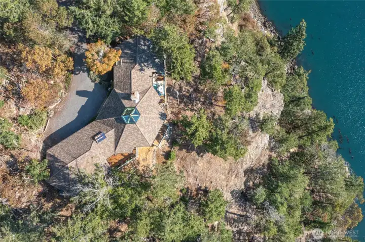 The home is dramatically perched over Deer Harbor.