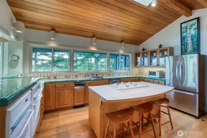 There is a generous kitchen island with seating for three.