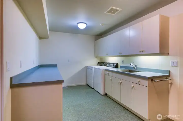 The laundry and work room has expanded storage and counterspace.