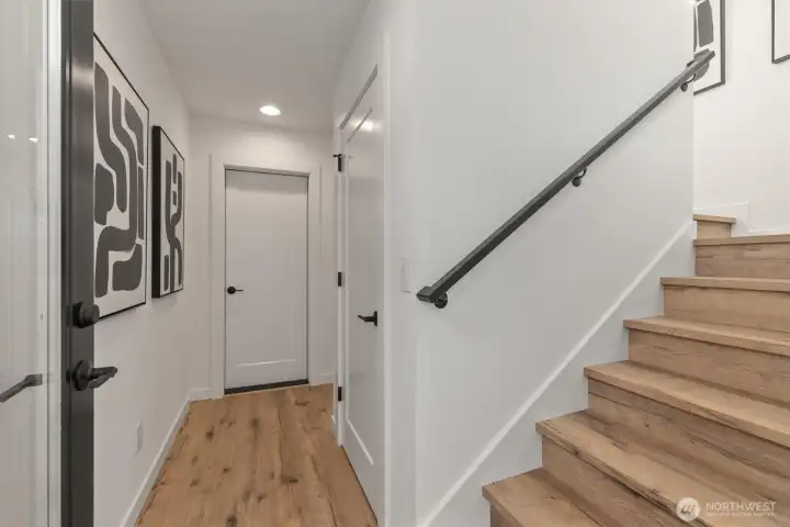 Foyer with hallway to bedroom and full bathroom. Staurs to Level II.