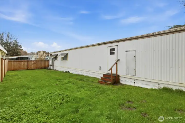 Plenty of room in the back yard. Door off kitchen would give access to yard if new owner built a deck or staircase