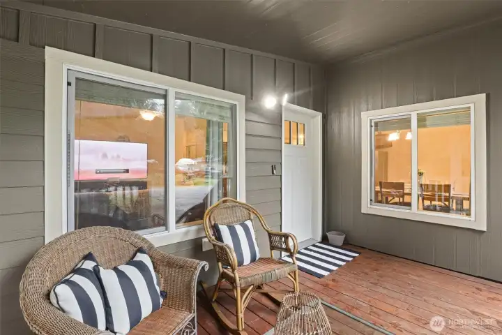 Covered front porch offering a comfortable, year-round outdoor seating space.