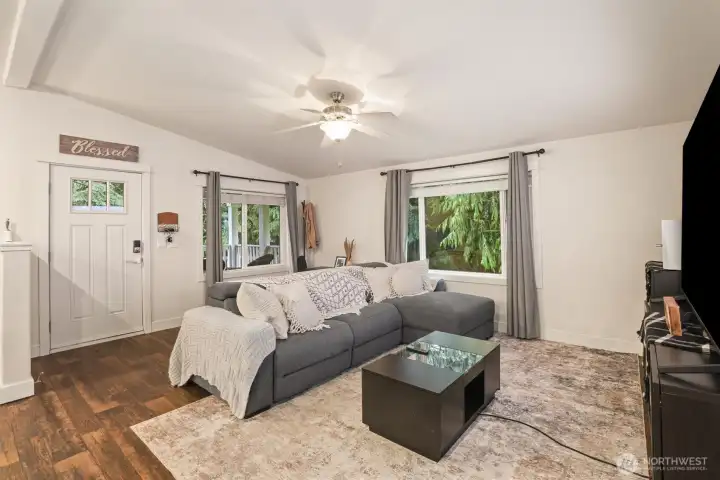 Living room anchored by natural light and positioned for comfortable gathering.