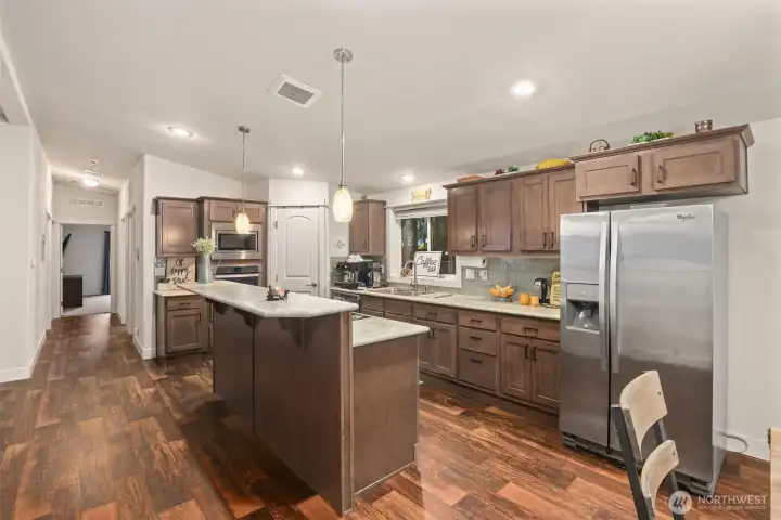Spacious kitchen with large island, ample cabinetry, and generous prep space.
