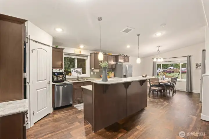 Seamless connection from kitchen to dining area, creating a natural gathering space.