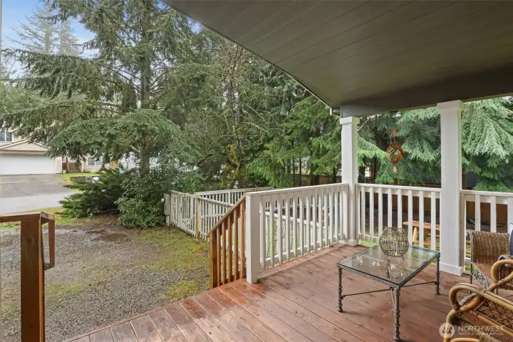Elevated porch overlooking the front yard with a quiet, tucked-away setting.