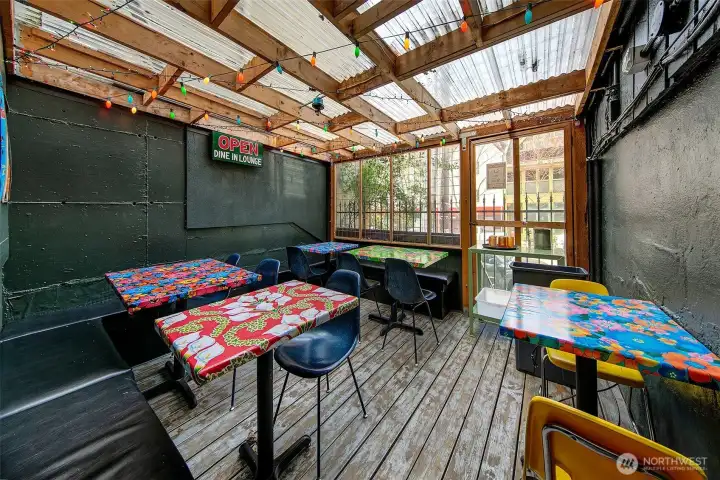 Covered outdoor dining space in the commercial space of 1201 E Denny Way.