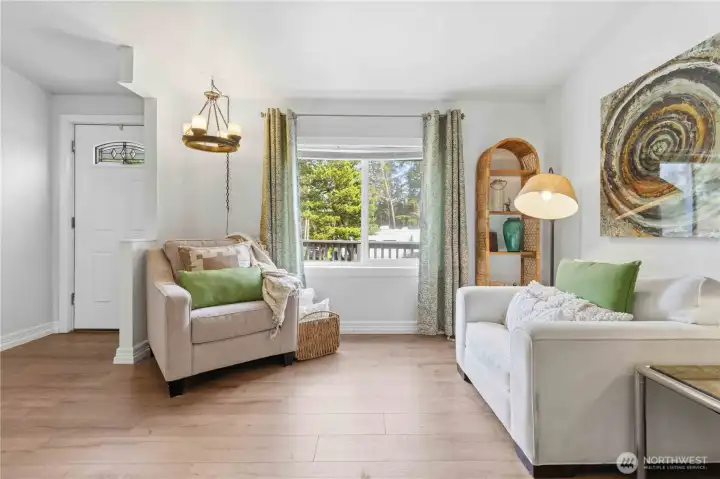 Front living room is complete with fresh paint, durable vinyl plank flooring and new light fixtures.