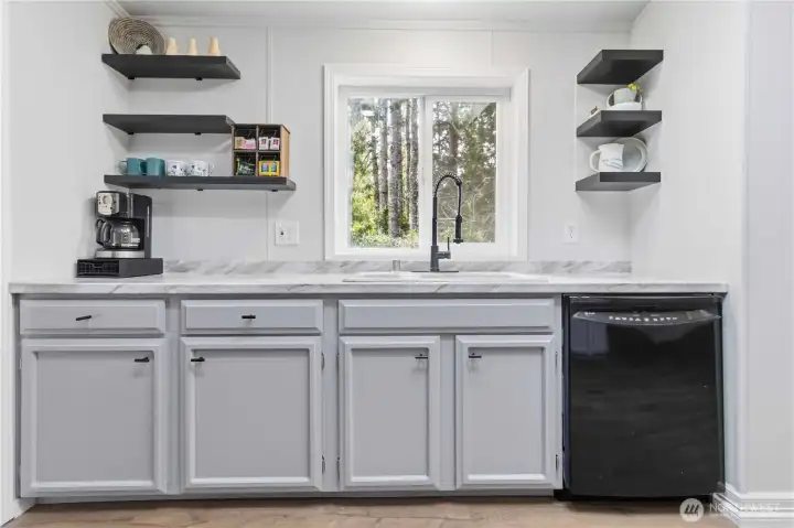 Kitchen window overlooks the back yard.
