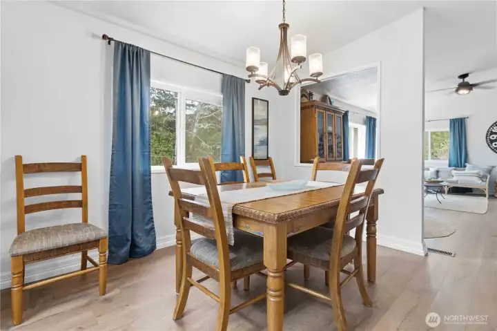 Dining room boasts fresh paint, new flooring and a new lighting fixture.