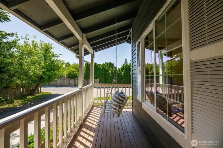 Coffee and a book in this wooden porch swing