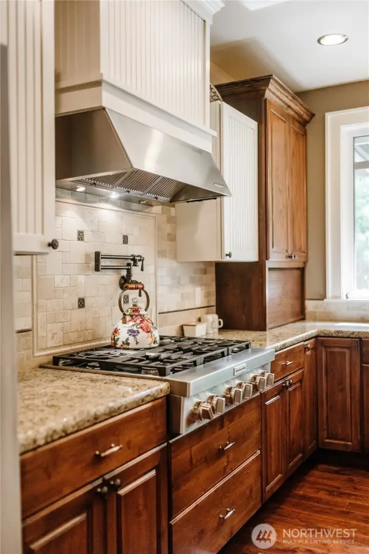 Gas range with pot filler above.