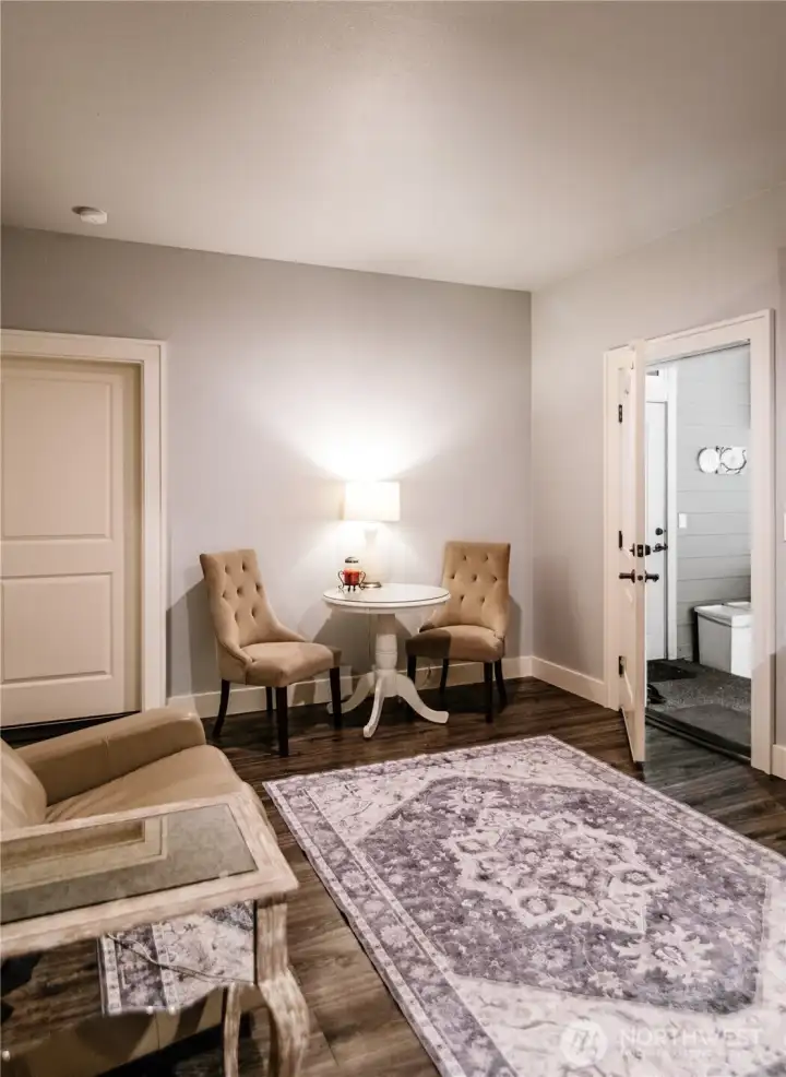 Seating area in the apartment with a door that goes out to the outdoor kitchen.