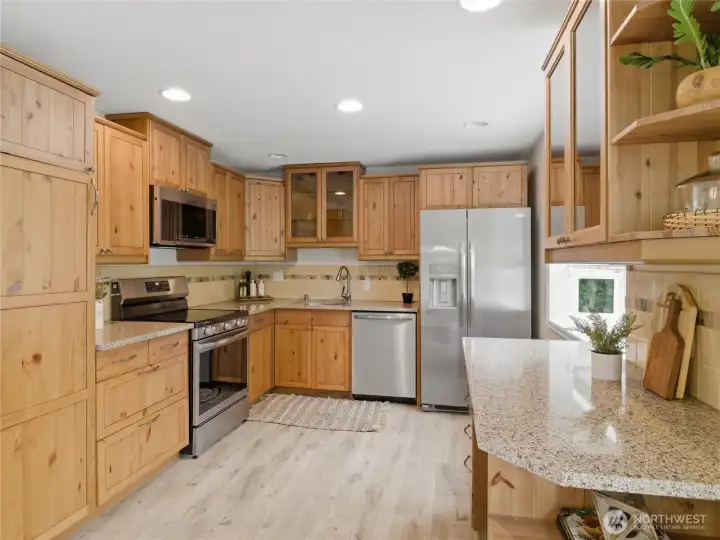 Updated kitchen with granite slab counters, and BRAND NEW stainless appliances.