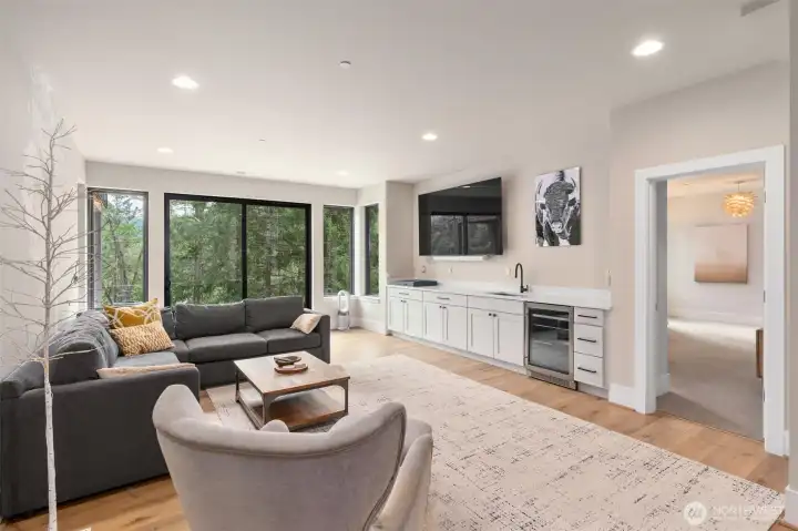 Downstairs Theater / Rec Room         Samsung Smart 85” Mounted TV with electrical outlet installed   Sonos - ARC 5.0.2 Channel Smart Soundbar with Dolby Atmos   Apple TV 4K   Philips Hue Gradient Light strip behind TV   Buster & Punch kitchen faucet   Stenciled / Painted tree   2 x West Elm wall light fittings   Exterior Windows Bird Divertor Window Film : Bird Divert to prevent bird strikes