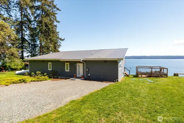 The fenced garden, raised beds, paver patio with a propane fire pit, and a solar-lit path to the terrace create your own outdoor sanctuary