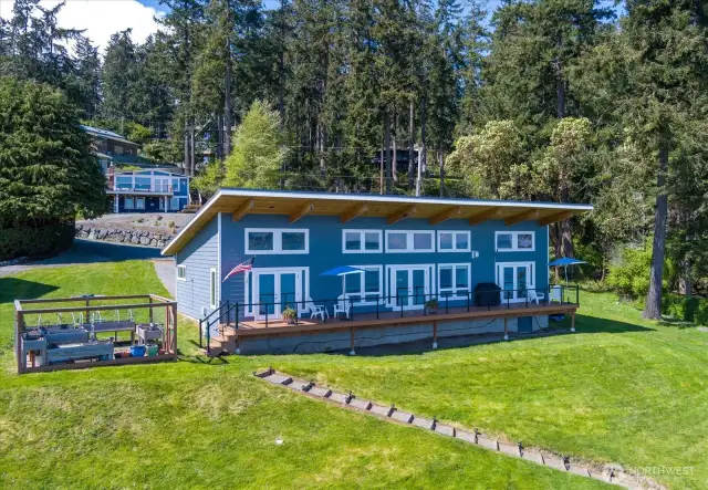 One of a kind property, lovingly decorated...to the left is the fenced off raised bed garden to the right are the steps to the propane firepit!