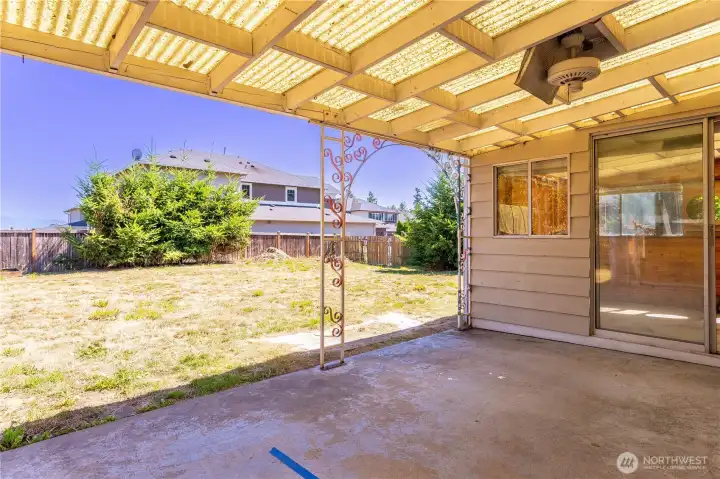 Covered patio off the kitchen, former hot-tub/spa room to right.