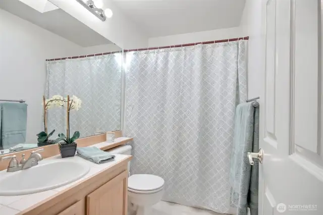 The hallway bathroom upstairs featuring a bathtub