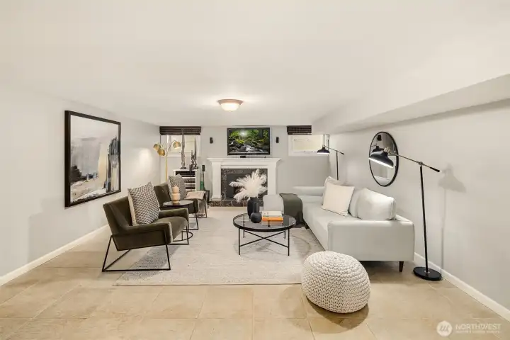 The lower level recreation room with gas fireplace makes a great space for cozy gatherings or movie nights.