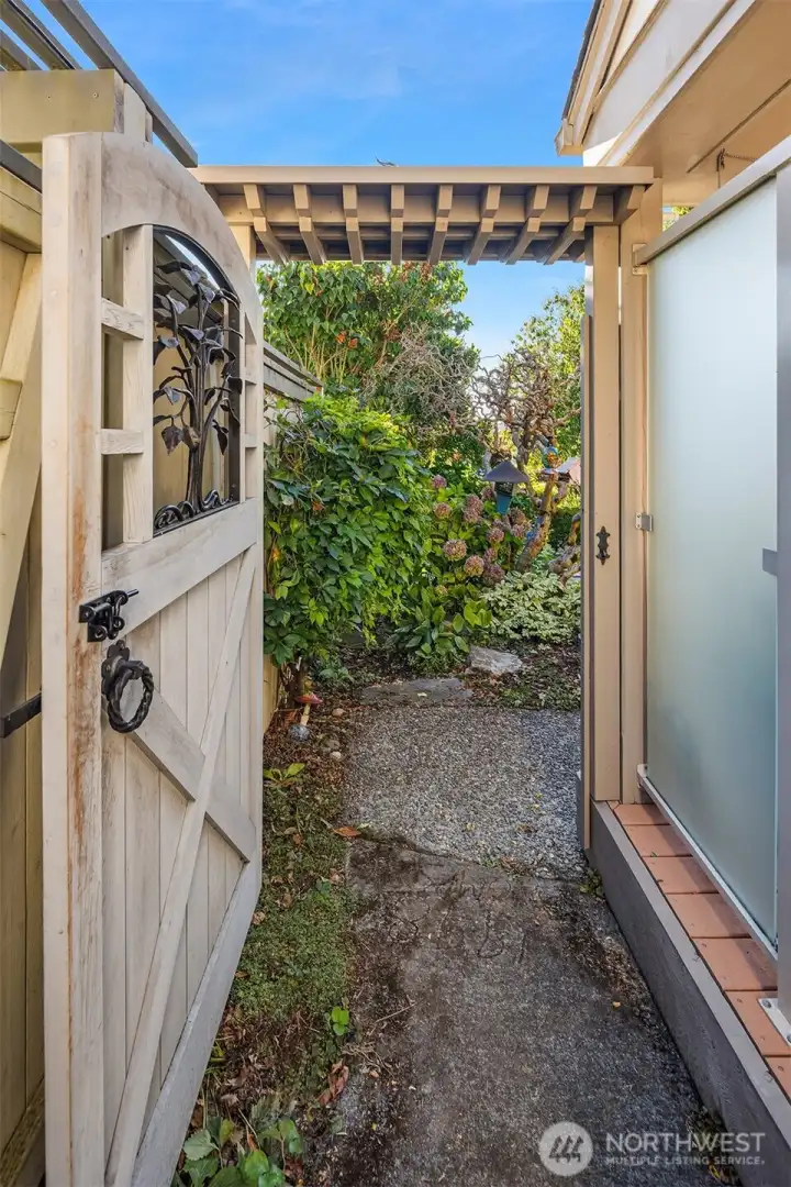 The custom Tree Of Life gate beckons you to the back yard.