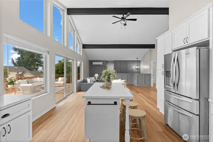 The kitchen opens to water views through the slider and deck beyond