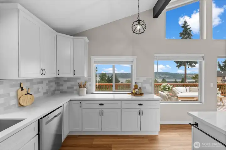 Morning light through the kitchen windows -- backsplash detail, trees, and water