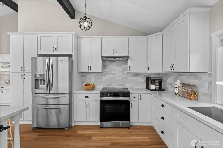 Full appliance wall with tile backsplash and generous counter space
