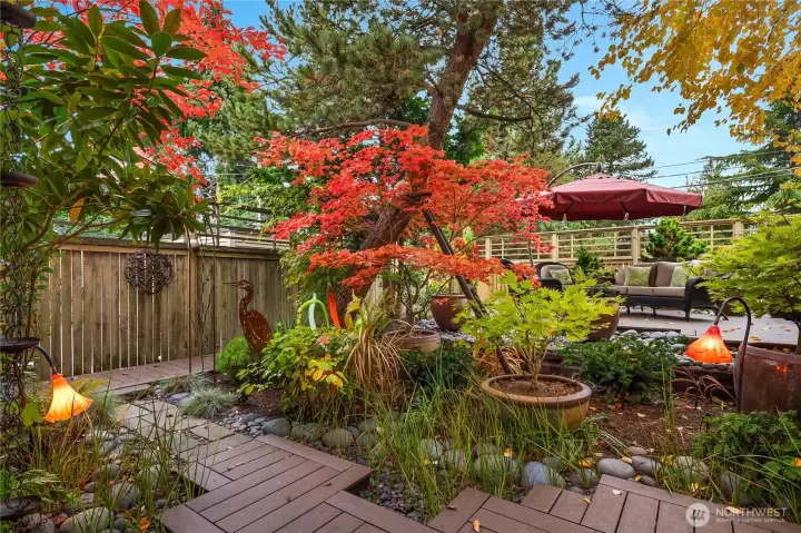 Multi-layered plantings of evergreen and deciduous shrubs and trees for year-round interest.