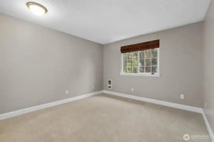 Primary bedroom overlooking backyard.
