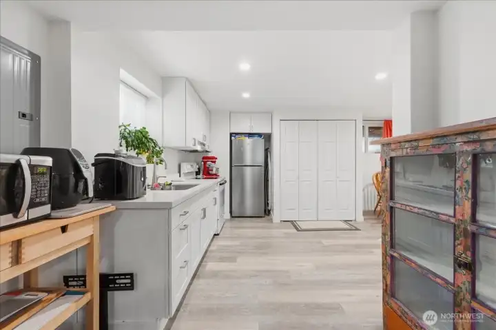 Lower level kitchen with access to the front and back yards. The laundry center is in the closet.