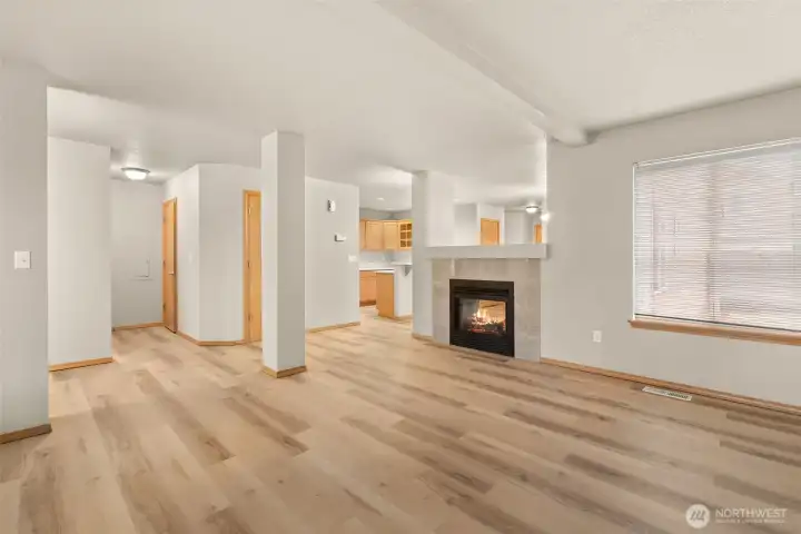 Living room/dining room share a wonderful pass-through gas fireplace.
