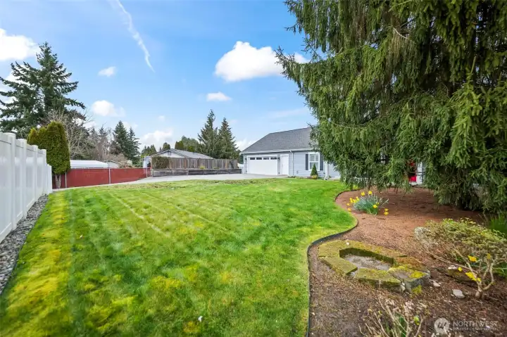 Property has a generous yard, thoughtful landscaping, and is fenced except for the driveway.