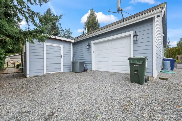 Garage has another electronic door leading out to gate that borders pick up zone for Browns Pt Elementary. Owner says the school has always been a wonderful neighbor and it's nice to have an extra exit from garage on other side of property.