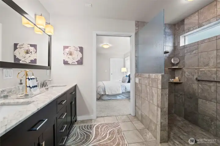 Primary ensuite bathroom boasts dual sinks, heated floors, and walk-in shower.